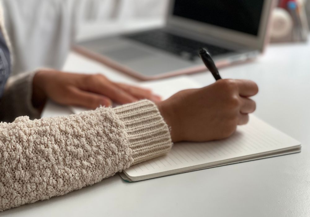 Woman journaling on her desk