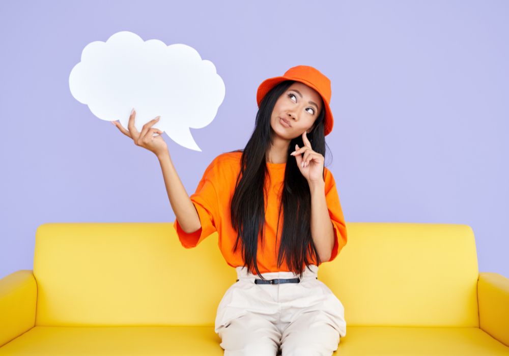 Woman sitting and thinking about how to declutter your mind.