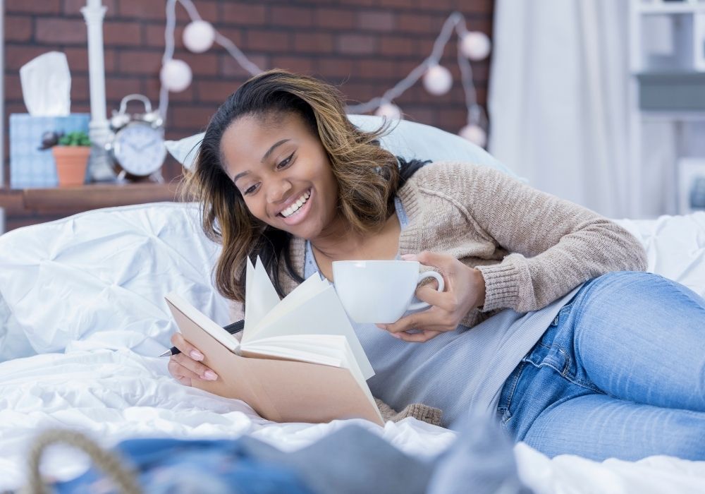 Woman reading a manifestation book.