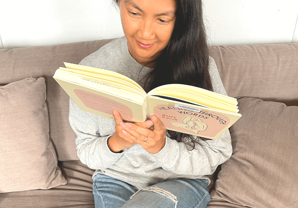 Woman reading on the couch as one of her list of passions